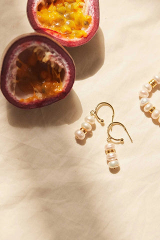 Close-up of Aline Pearls Earrings showing pearls and golden details