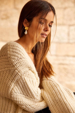 Close-up of Baroque Earrings showing organic pearl shape and golden details