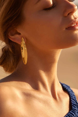 Model wearing Cannes Glossy Earrings – modern elegance