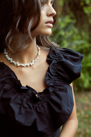 Close-up of Celeste Pearls Necklace showing pearls and golden details