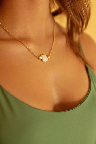 Close-up of pearls and 24K gold-plated chain details