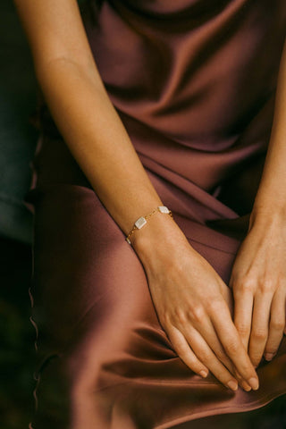 Close-up of León Pearls Bracelet showing luminous pearls and premium charms