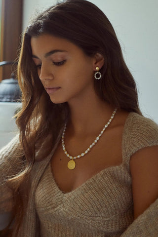 Close-up of Pearly Circle Earrings showing pearls and gold-plated finish