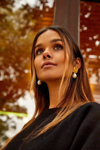 Close-up of Pearly Drop Earrings showing luminous pearls and gold finish