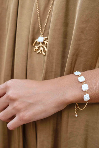 Close-up of Seaweed Pearl Necklace showing luminous pearl and marine pendant