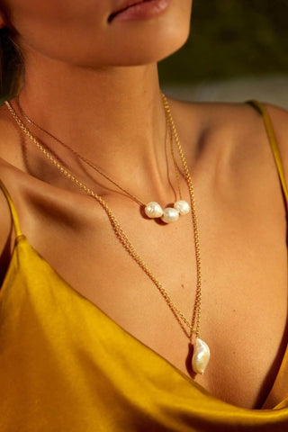 Close-up of XL Baroque Necklace showing baroque pearl and gold finish